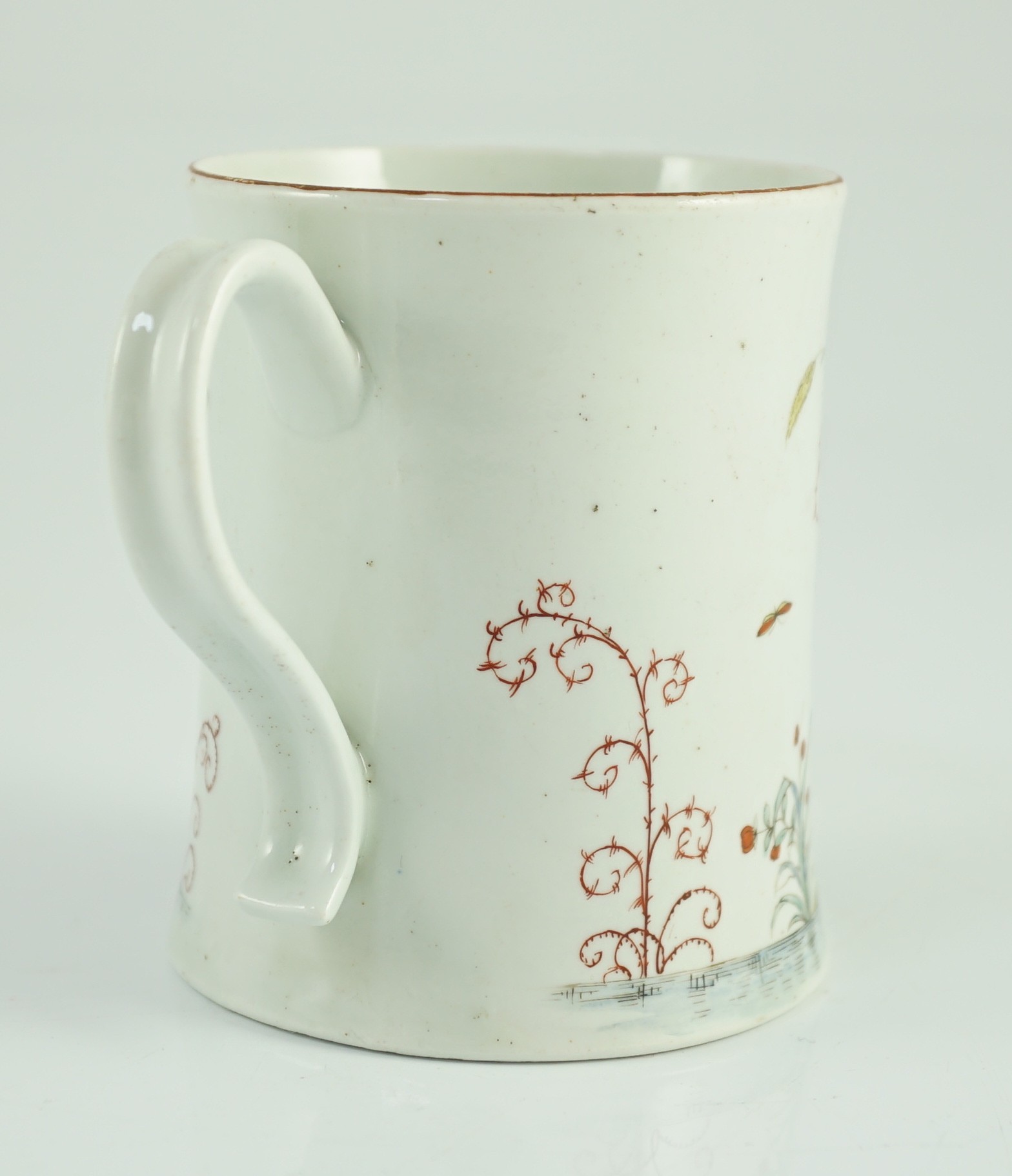 A rare Worcester polychrome 'flower and rockwork' small mug, c.1753-54, 9cm high